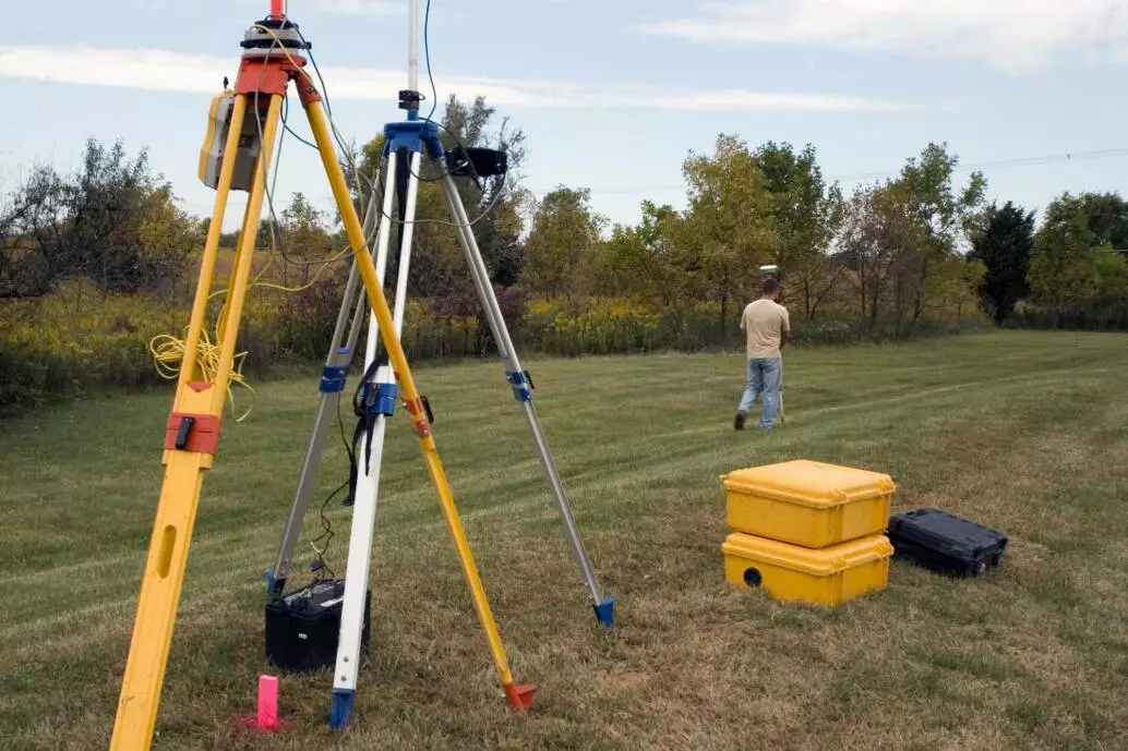 Surveyor examines unfenced pasture
